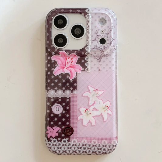 A clear phone case with a pink and brown patchwork design, featuring pink and white lilies, polka dots, floral borders, and decorative buttons, shown on a light beige background.