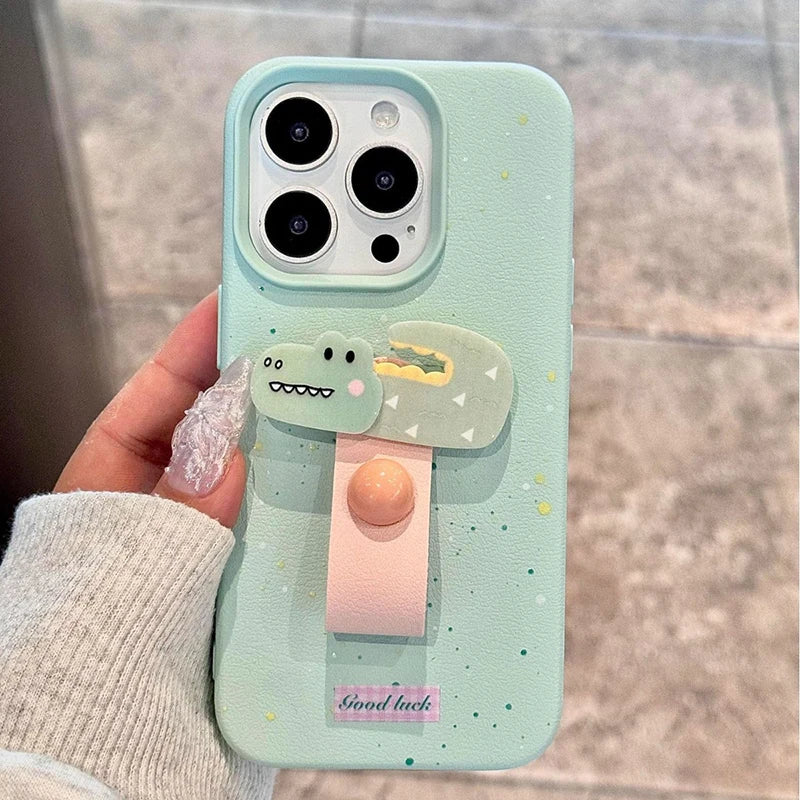 Phone case with a cartoon character design held by a hand against a neutral background