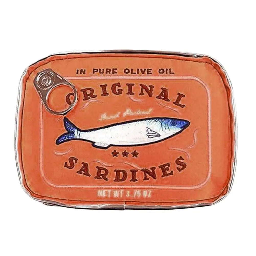 A novelty clutch purse designed to look like a vintage sardine can, featuring an orange-brown textured body, a silver metal pull tab, and printed graphics of a sardine with the text 'ORIGINAL SARDINES'.