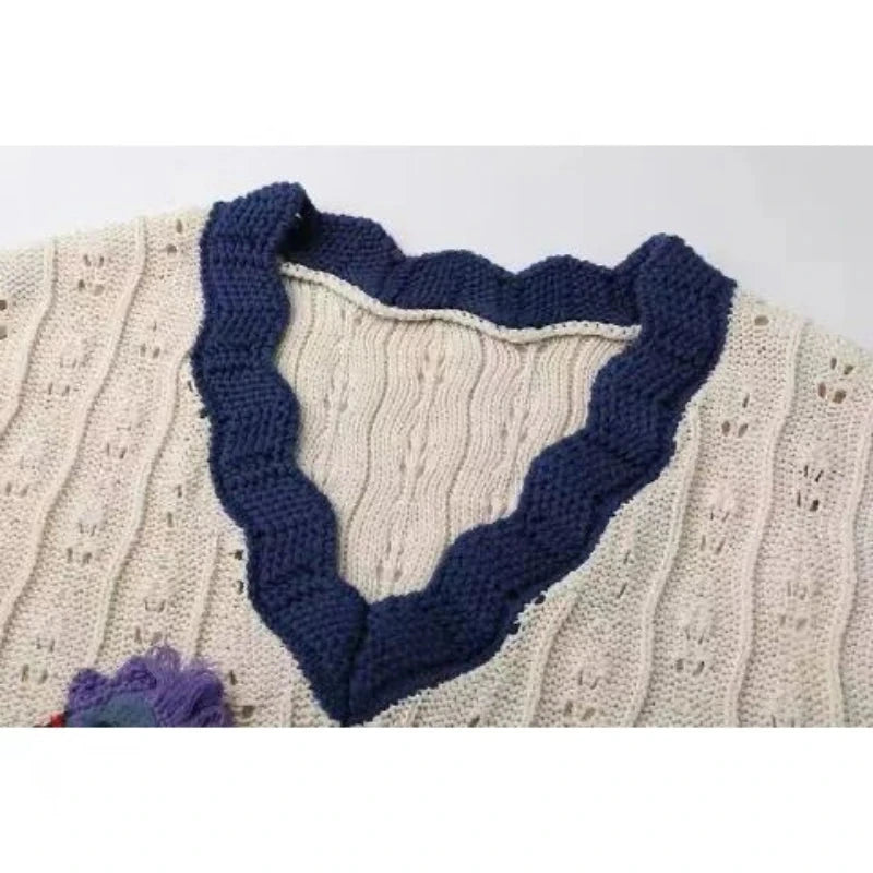 Close-up of a knitted garment with a blue border on a white background
