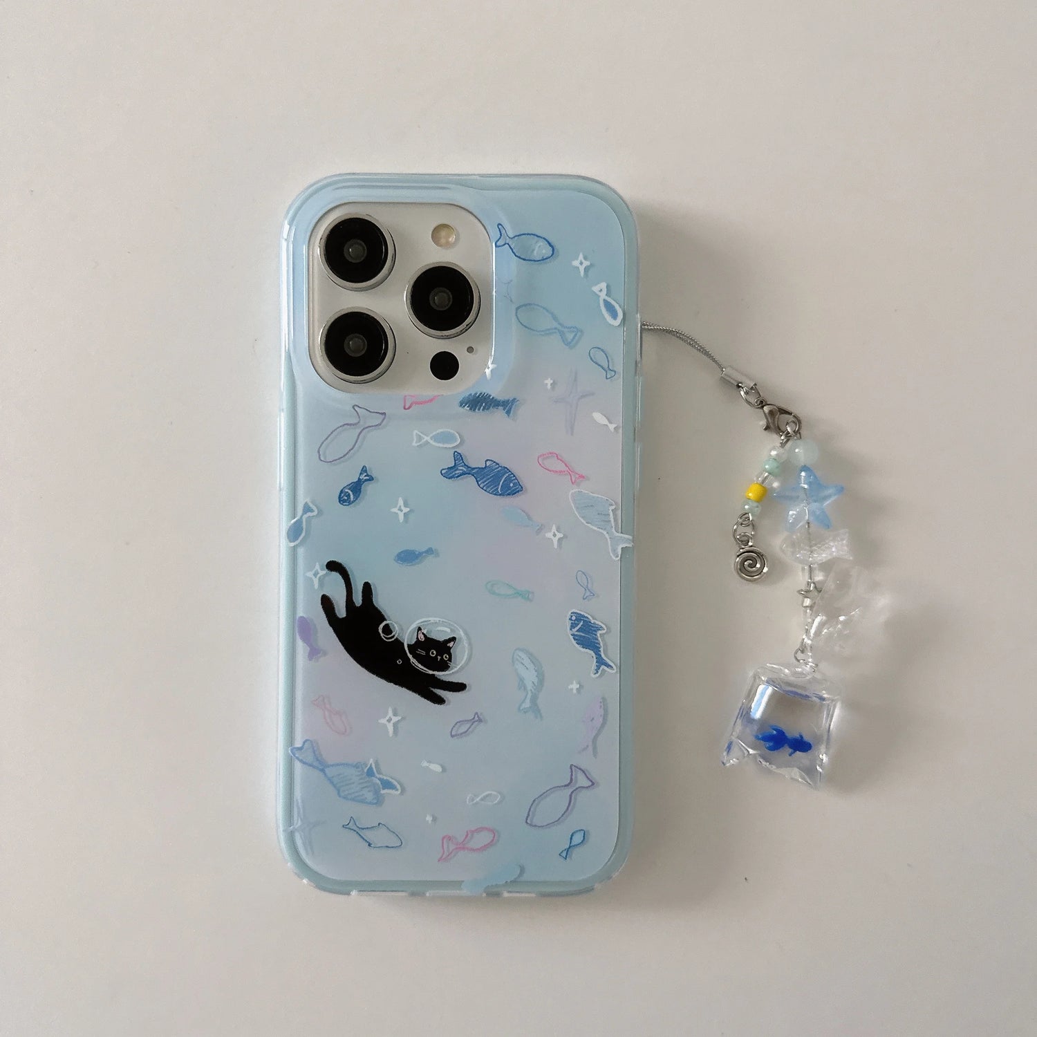 Phone case with fish pattern and black cat design on a light blue background