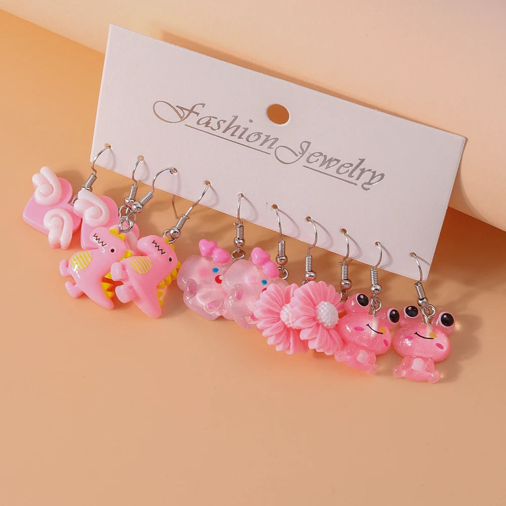 Set of pink earrings on a 'Fashion Jewelry' card against a peach background