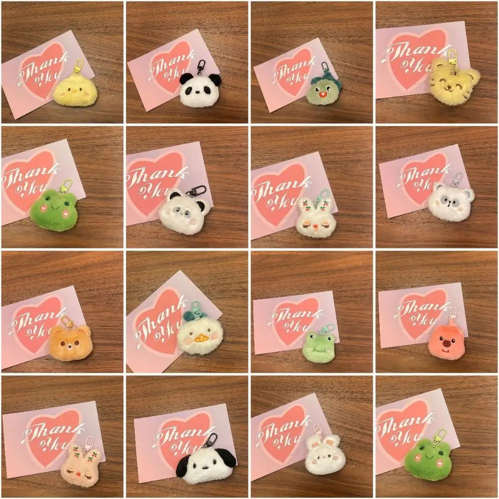 A 4x4 grid collage showing multiple small plush character keychains placed on pink 'Thank You' cards, all arranged on a wooden surface. The plushies include yellow, green, white, black, and peach tones, and the cards repeatedly say 'Thank You' with a pink heart.
