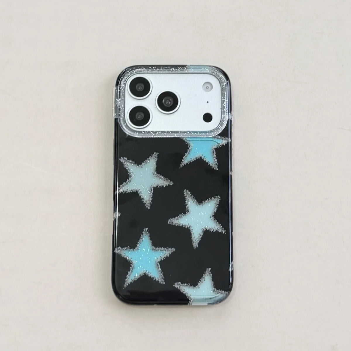 Phone case with blue star pattern on a light gray background