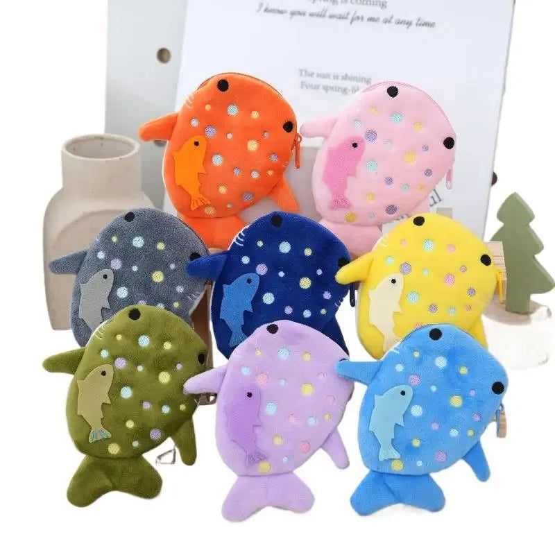 Set of colorful fish-shaped pouches with polka dot patterns on a white background.