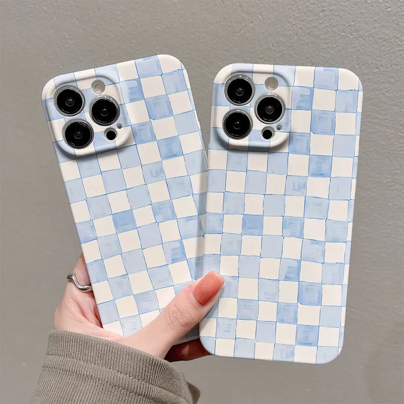 Two phone cases with a blue and white checkered pattern held by a hand against a gray background.