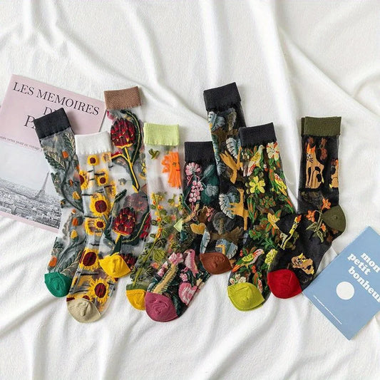 Colorful floral-patterned socks on a white fabric background with a magazine and card.