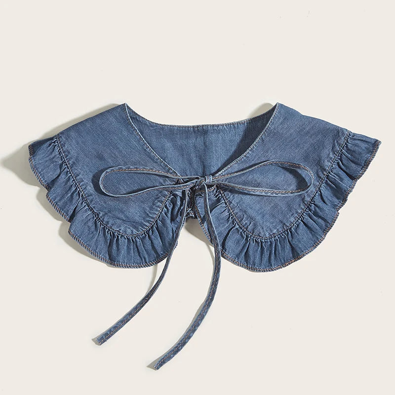 Denim collar with ruffles and a bow on a beige background