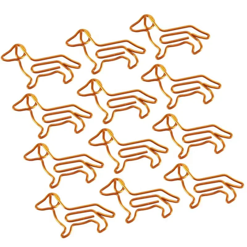 Twelve small dog-shaped wire clips arranged in a grid on a plain white background.