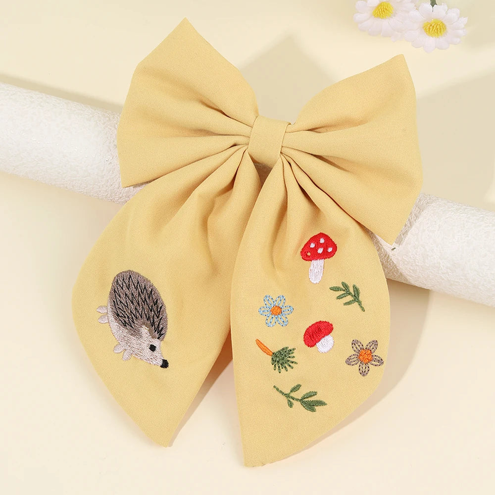 Yellow bow with embroidered designs on a beige background