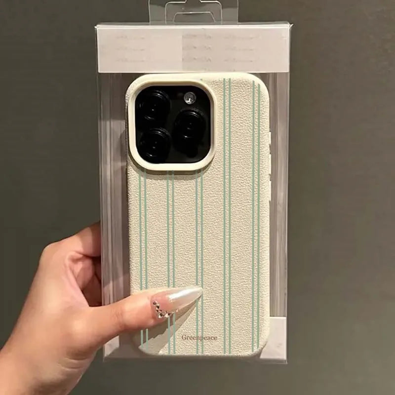 Phone case with polka dot pattern held by a hand against a dark background