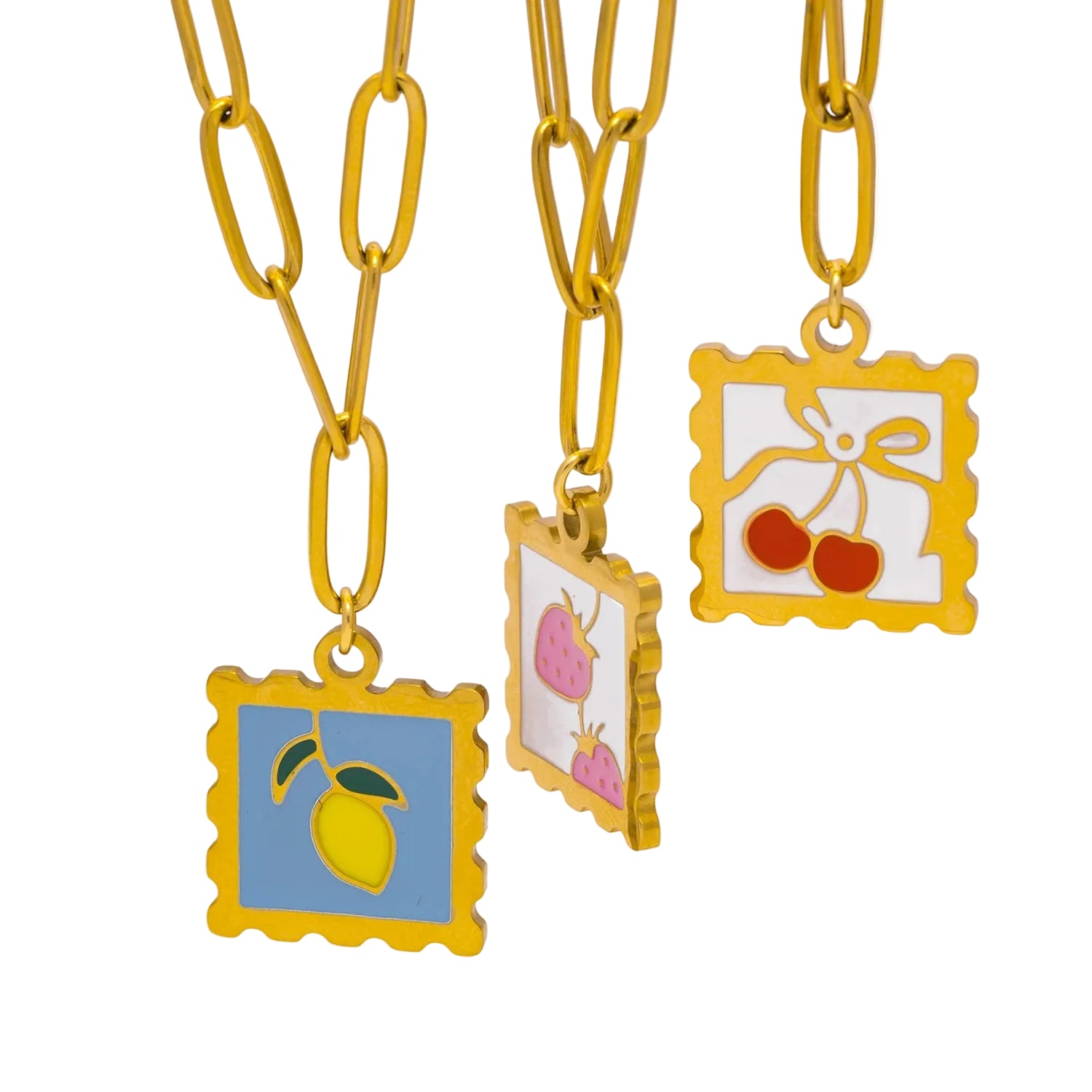 Three colorful pendant necklaces with fruit and flower designs on a white background