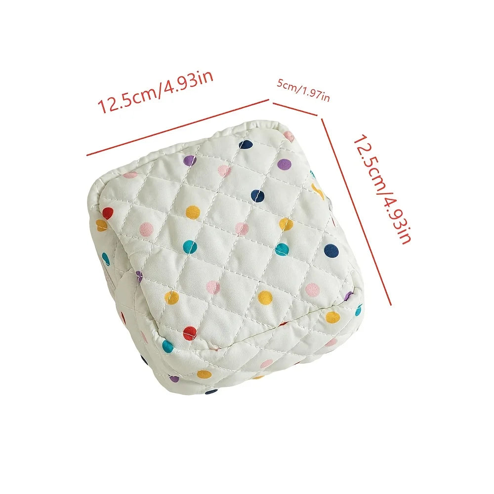 Small quilted pillow with colorful polka dots and measurements on a white background