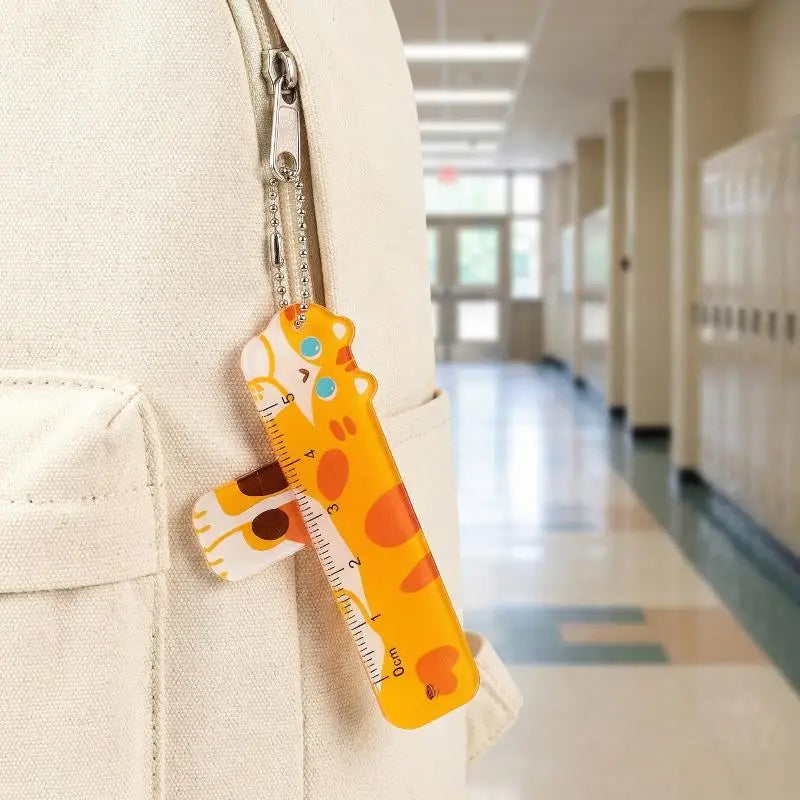 Giraffe-shaped ruler keychain attached to a backpack in a school hallway