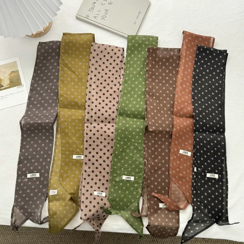 Set of patterned ties in various colors on a white surface.