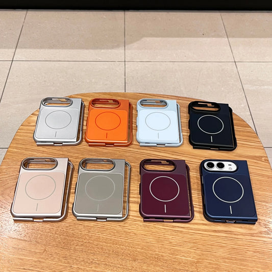 Eight magnetic phone cases in various colors arranged on a round wooden table, with a tiled floor visible in the background.