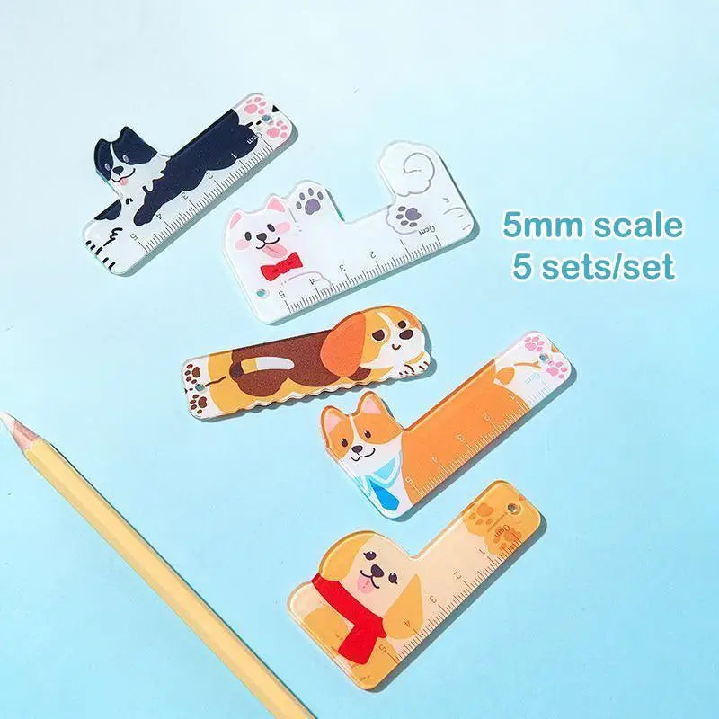 Set of cartoon animal rulers on a light blue background with a pencil.
