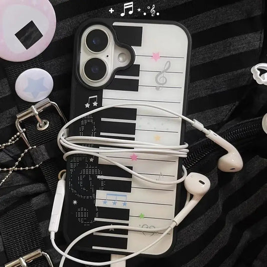 Phone case with piano design and earphones on a textured surface