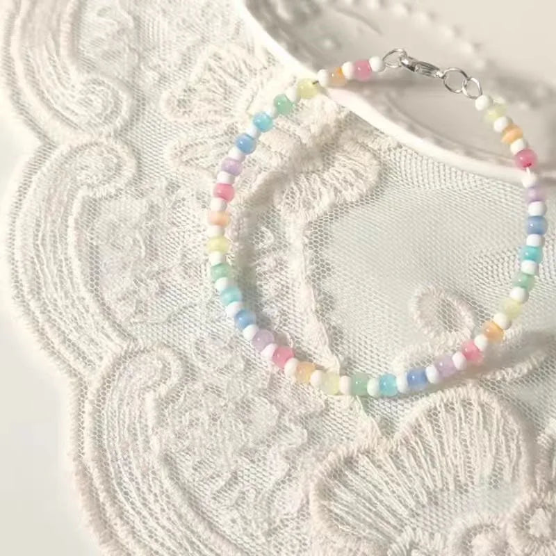 Colorful beaded bracelet on a textured white surface