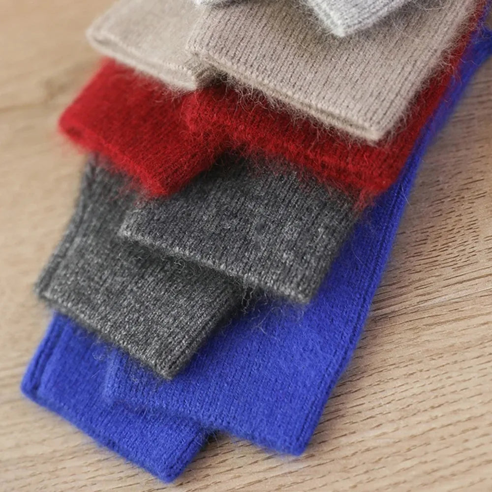 Stack of colorful socks on a wooden surface
