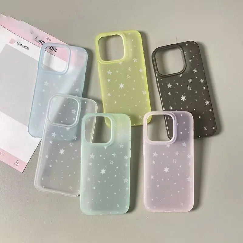 Six translucent phone cases with white star patterns in pastel shades of blue, yellow, gray, mint, and pink, arranged on a light gray surface.