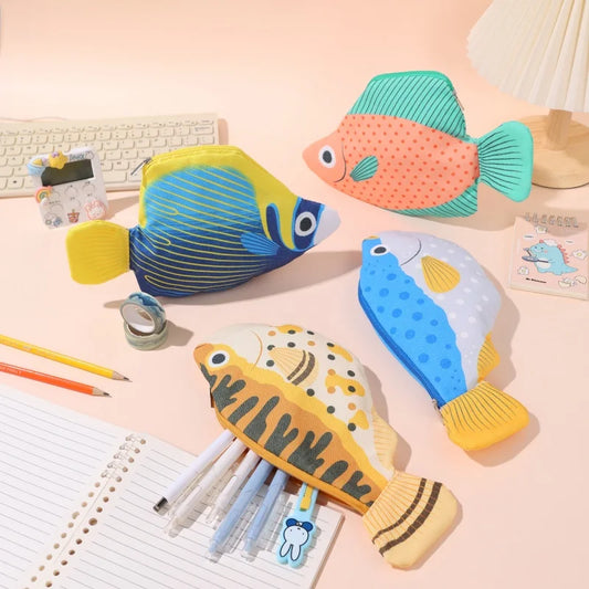Colorful fish-shaped stationery items on a desk with stationery supplies.