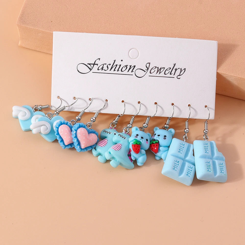 Set of colorful keychain charms on a 'Fashion Jewelry' card against a beige background