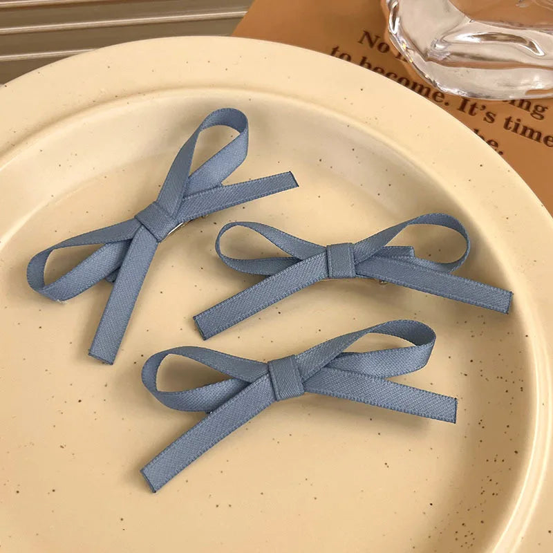 Three blue ribbons on a beige plate with a blurred background