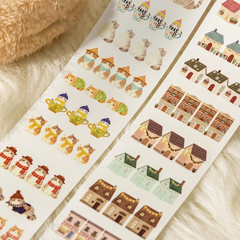 Sheet of decorative stickers featuring houses and animals on a textured surface.