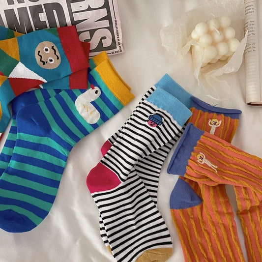 Colorful socks with various patterns on a white surface
