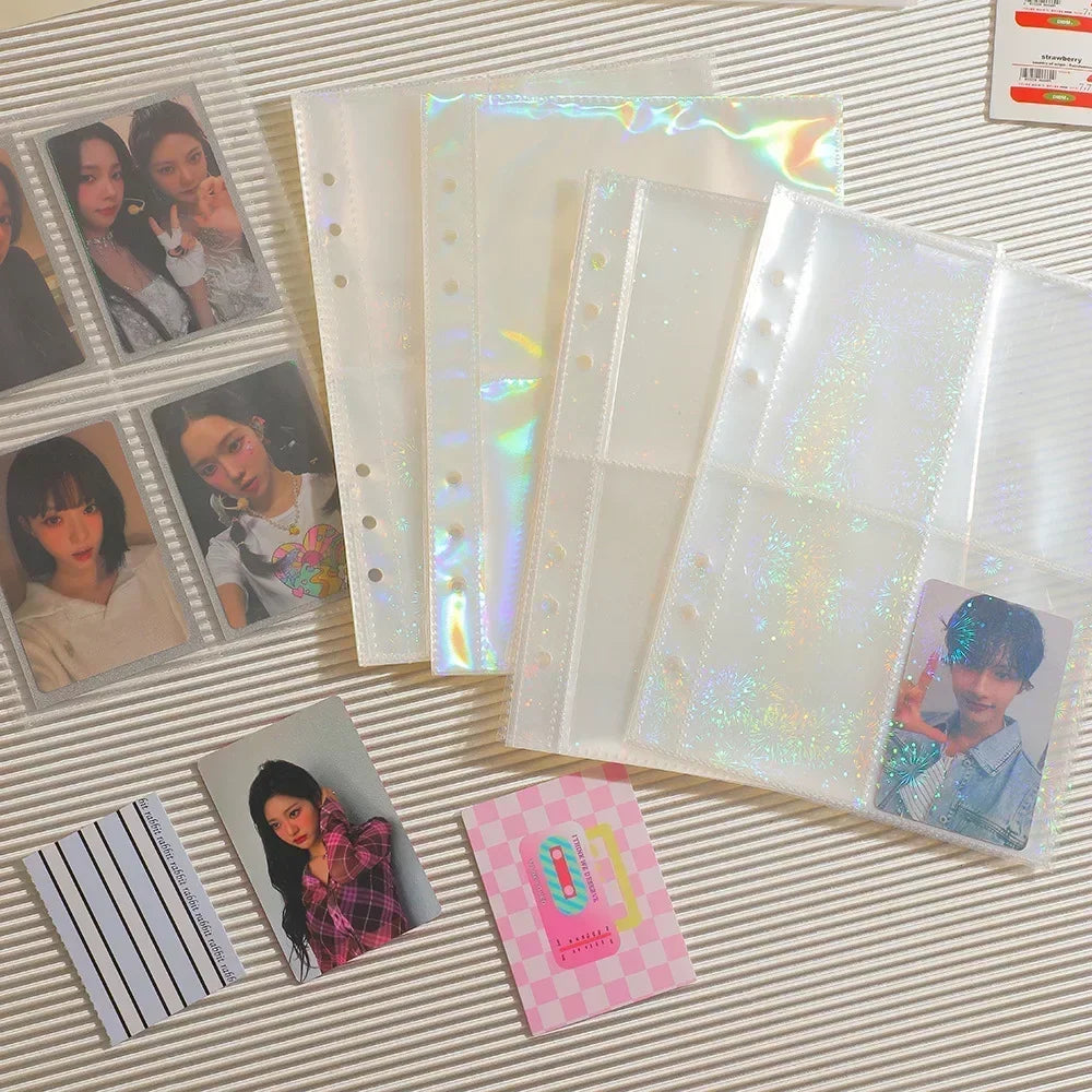 Collection of photo albums with holographic pages and printed photos on a striped surface.
