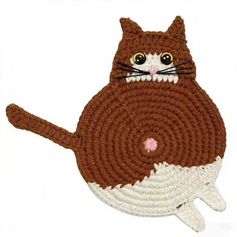 Crocheted cat-shaped item with brown and white colors on a white background