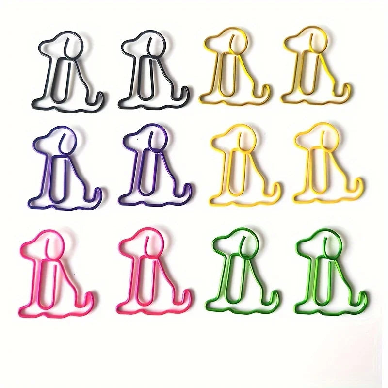 Twelve dog-shaped paperclips in assorted colors, including black, gold, purple, yellow, pink, green, and blue, arranged in a grid on a white background.