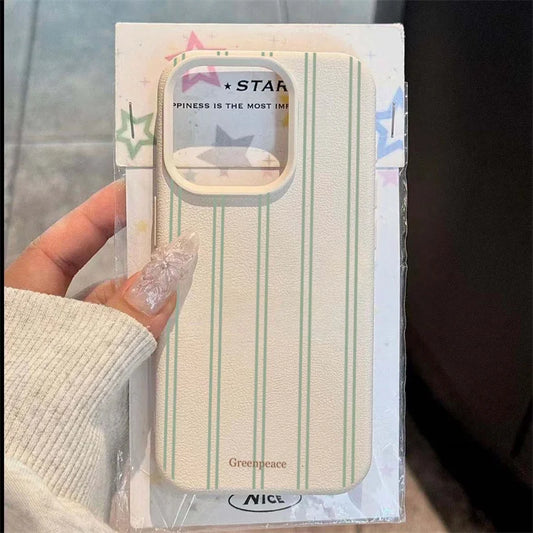 A hand wearing a cream knit sleeve holds a packaged phone case. The case has a textured cream background with thin mint green vertical stripes and a clear camera cutout.