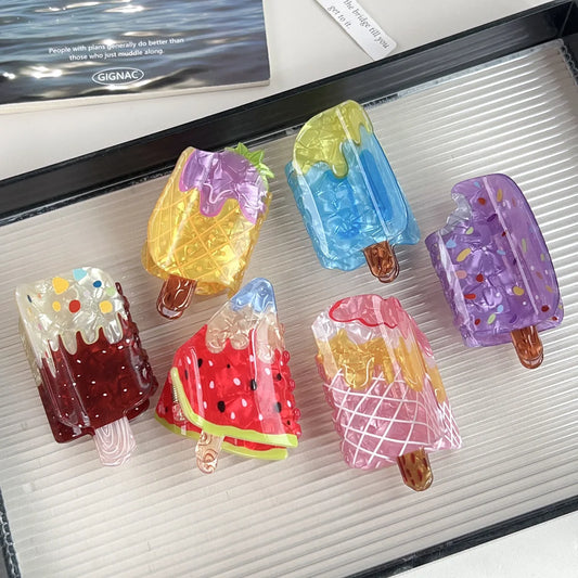 Set of colorful ice cream-shaped hair clips on a tray
