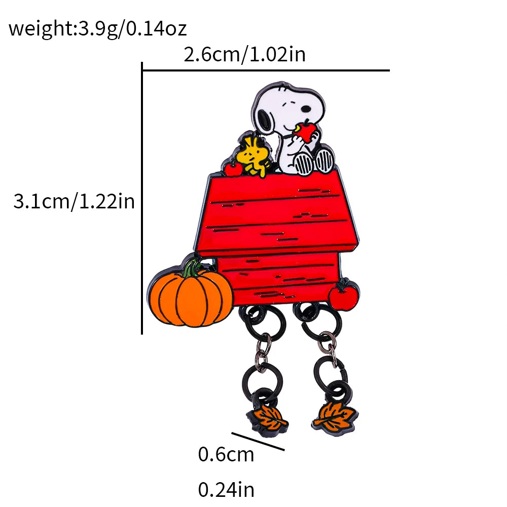 Peanuts Snoopy and Woodstock enamel lapel pin on a red dog house with pumpkin and hanging autumn leaves, shown with measurement lines and text indicating weight and dimensions on a white background.