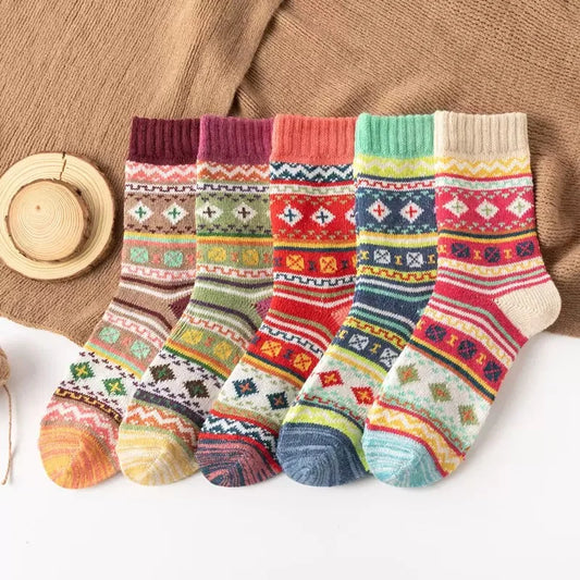 Set of colorful patterned socks on a textured surface