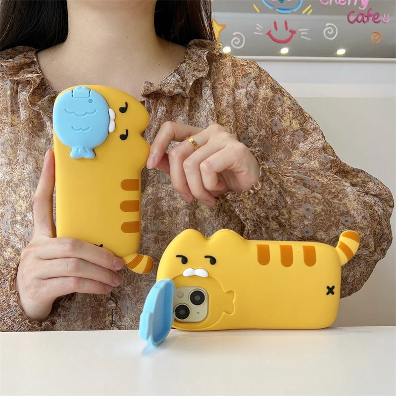 Person holding a yellow cartoon phone case with a blue whale design.