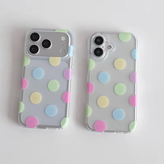 Two clear phone cases with pastel polka dots in pink, yellow, green, and blue, shown on silver smartphones against a light gray background.