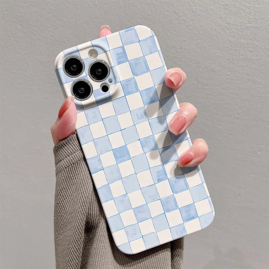 Phone case with blue and white checkered pattern held by a person against a gray background