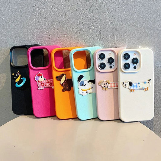 Set of colorful phone cases with cartoon dog designs on a gray background