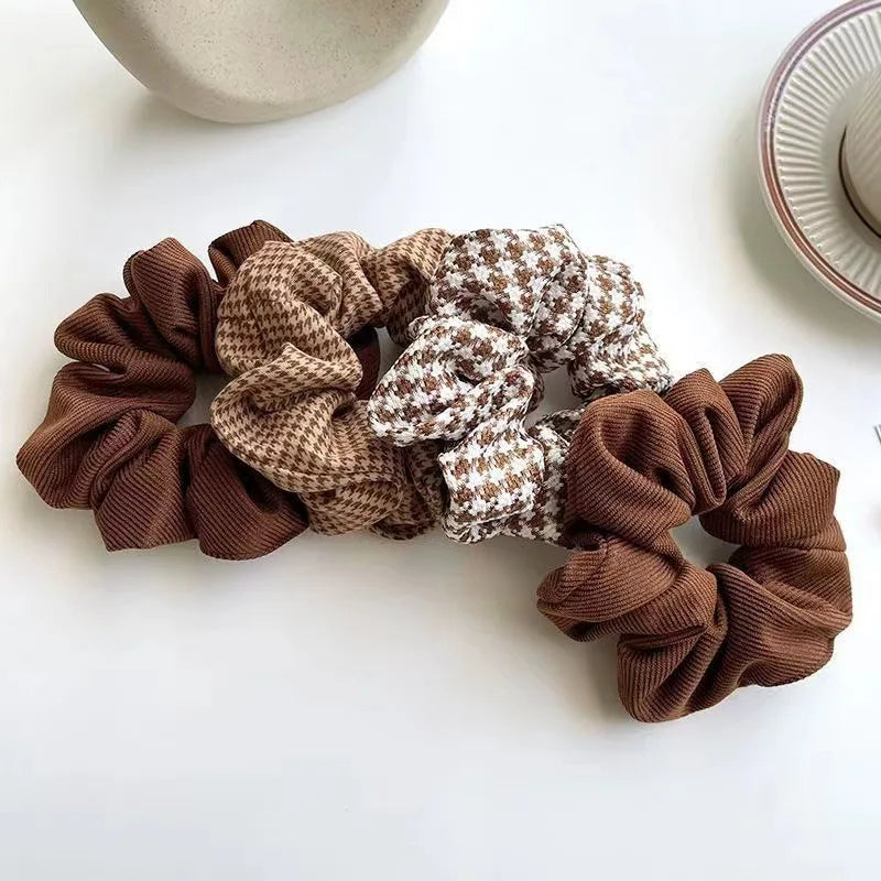 Set of brown scrunchies on a white surface