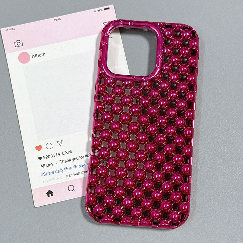 Pink beaded phone case on a gray background