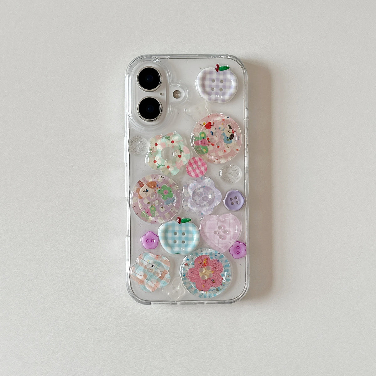 Phone case with decorative stickers on a light gray background