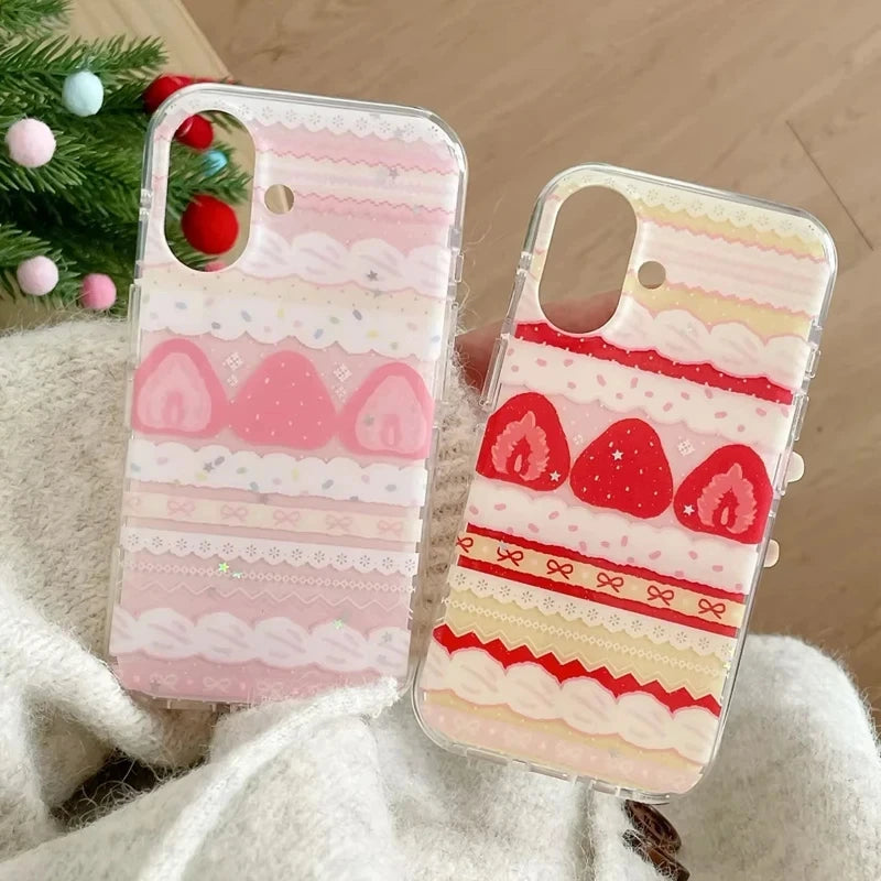 Two phone cases with strawberry and lace design on a soft surface.