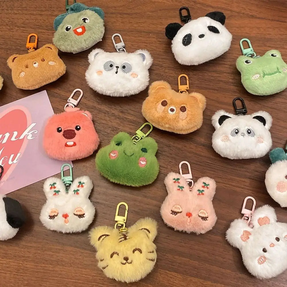 Collection of colorful plush keychains on a wooden surface