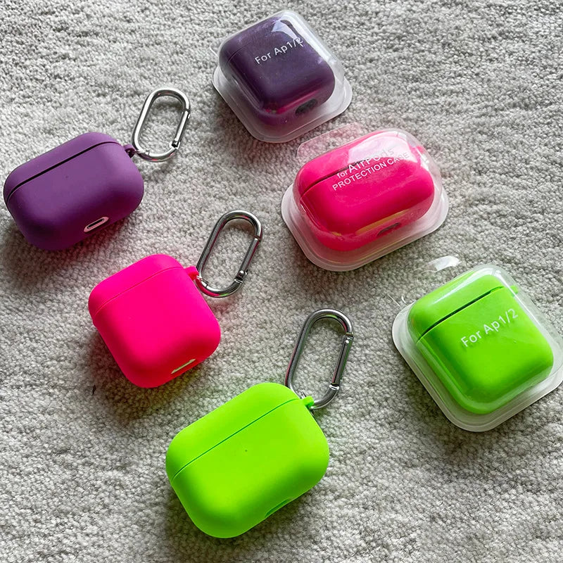 Colorful protective cases for Apple products on a textured surface
