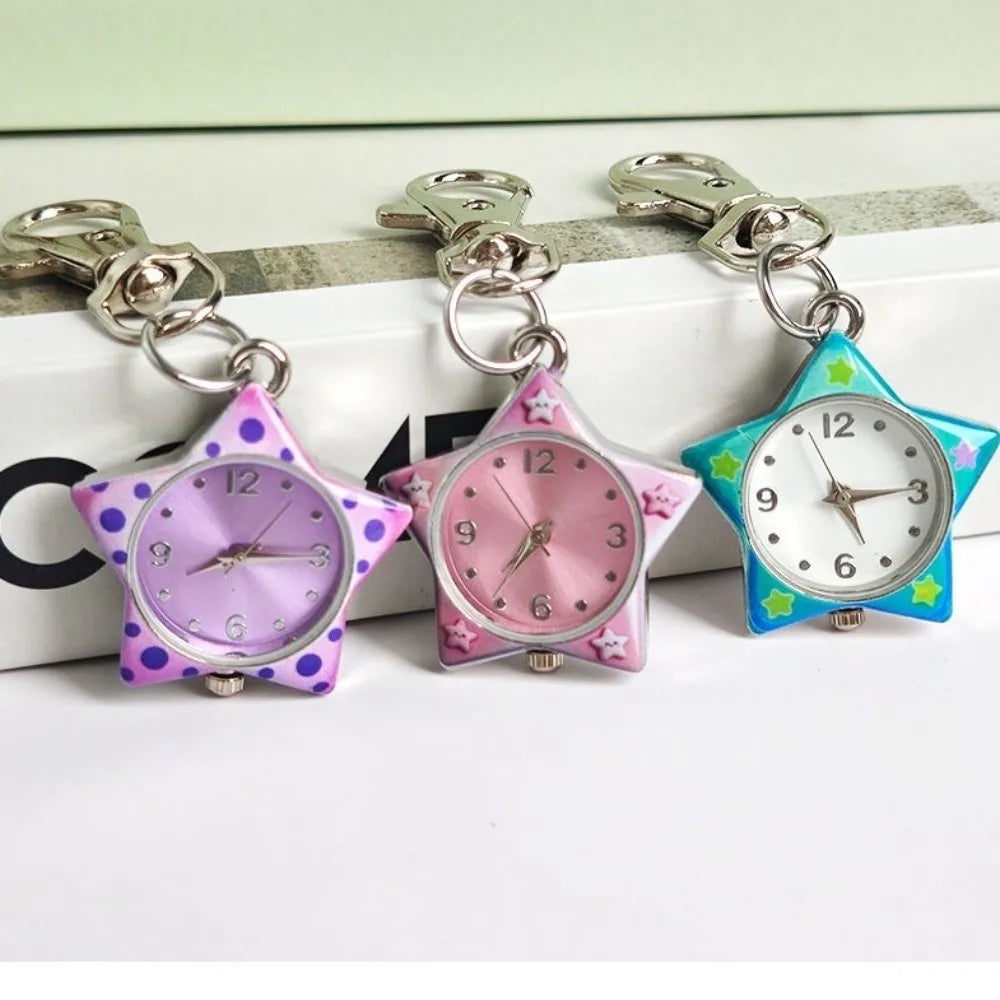 Three star-shaped pocket watches with keychains in purple, pink, and blue, displayed on a white surface.