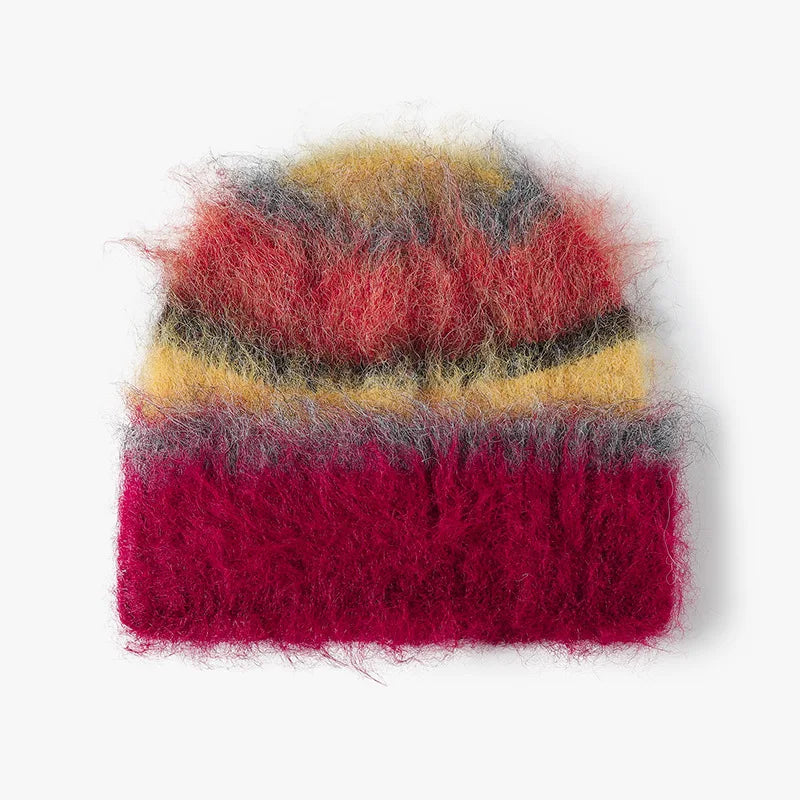 A fuzzy, mohair-style knit beanie hat with horizontal stripes of magenta pink, yellow, gray, and red, shown against a plain white background.