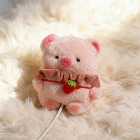 Plush toy pig with a bow and strawberry on a fluffy white background